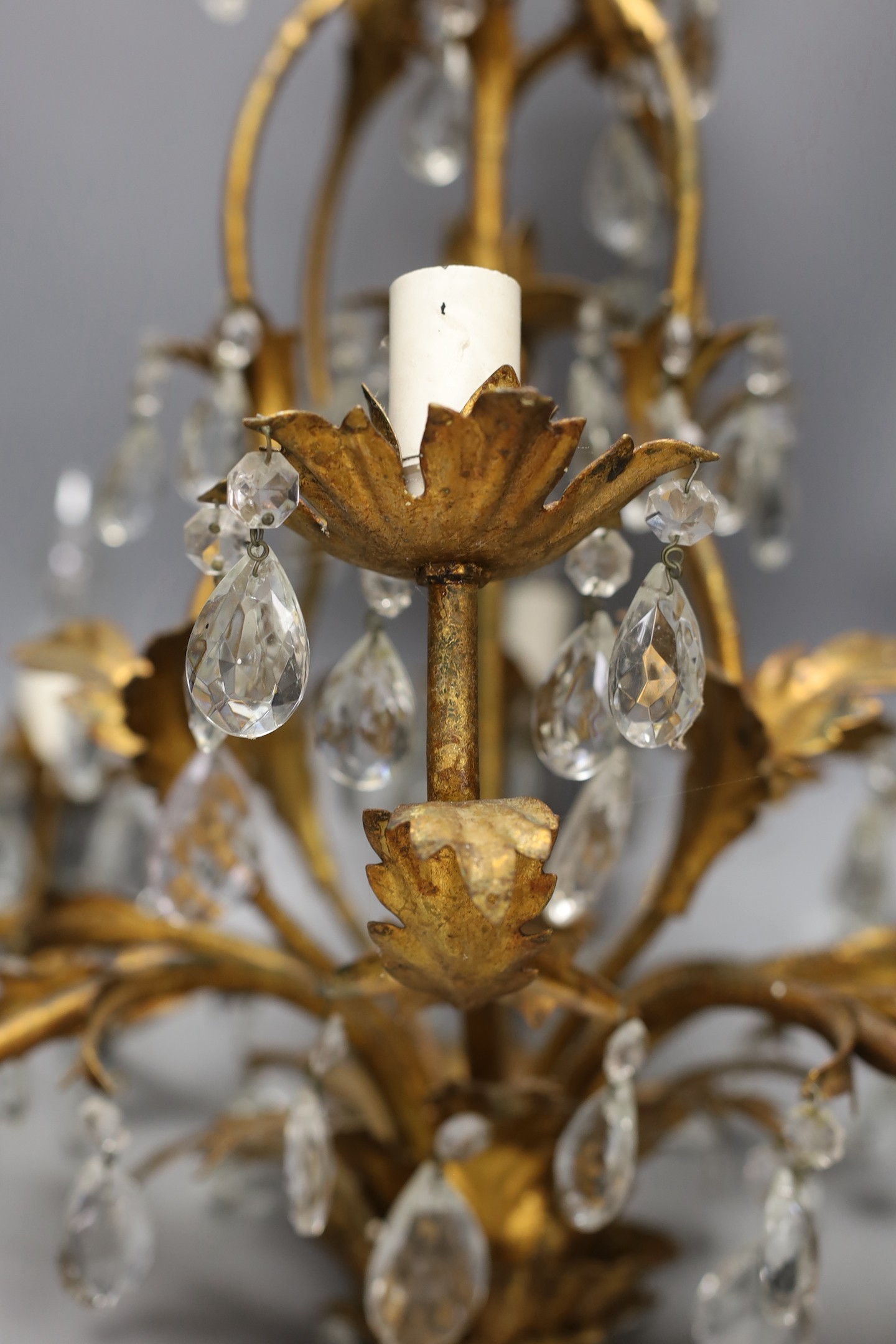 A French gilt metal and cut glass drop eight branch, electrolier, 58 cms high.